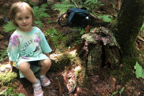 Young camper enjoying a rest in the woods.