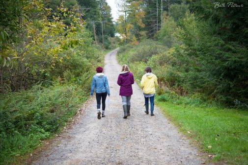 Caroline Campano and Amy Bright walk with Youth Education Director Tara Pratt