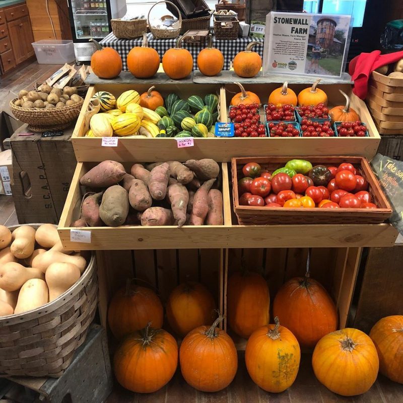 Fresh veggies in wooden bins ready to purchase